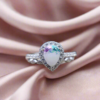 The Cassandra Teardrop Stacker Breastmilk Ring pure milk and pop of blue and purple leaf