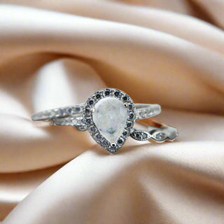 The Cassandra Teardrop Stacker Breastmilk Ring glass opaque white and dragon glass flecks